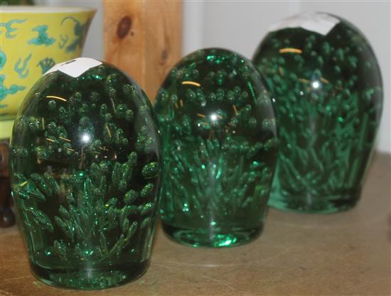 Three end-of-day glass doorstops